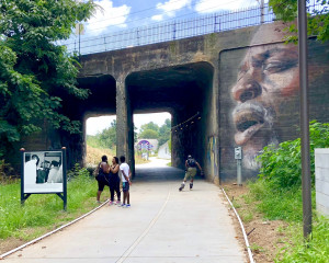 A panel from "Atlanta and the Civil Rights Movement, 1944-1968" on the Westside Trail, alongside "The Singer," mural by Suzy Schultz. Photo: John Becker