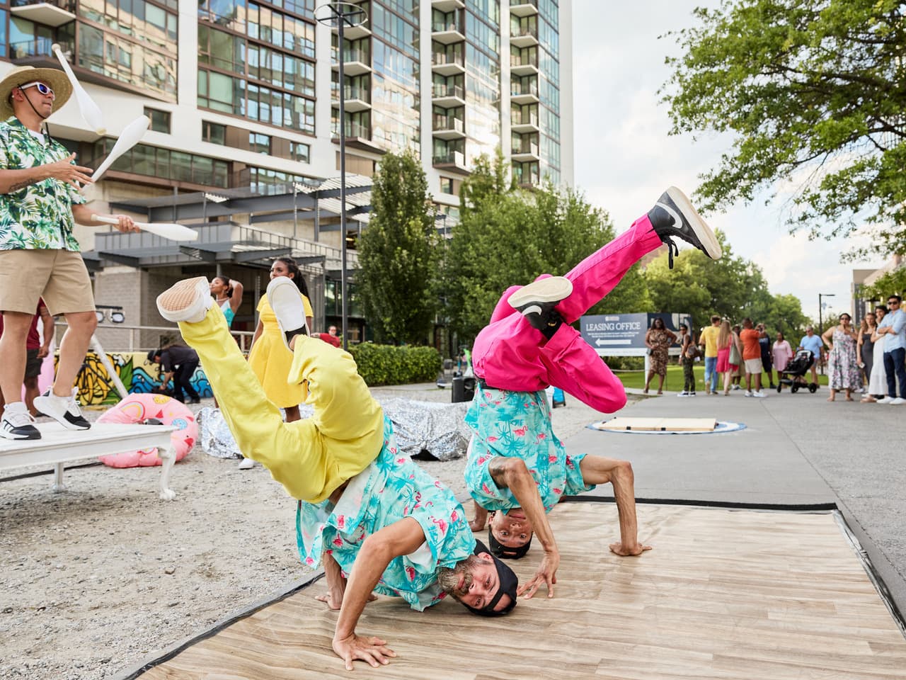A group of dancers dressed in Hawaiian shirts and bright pants break dance on part of the Beltline trail.