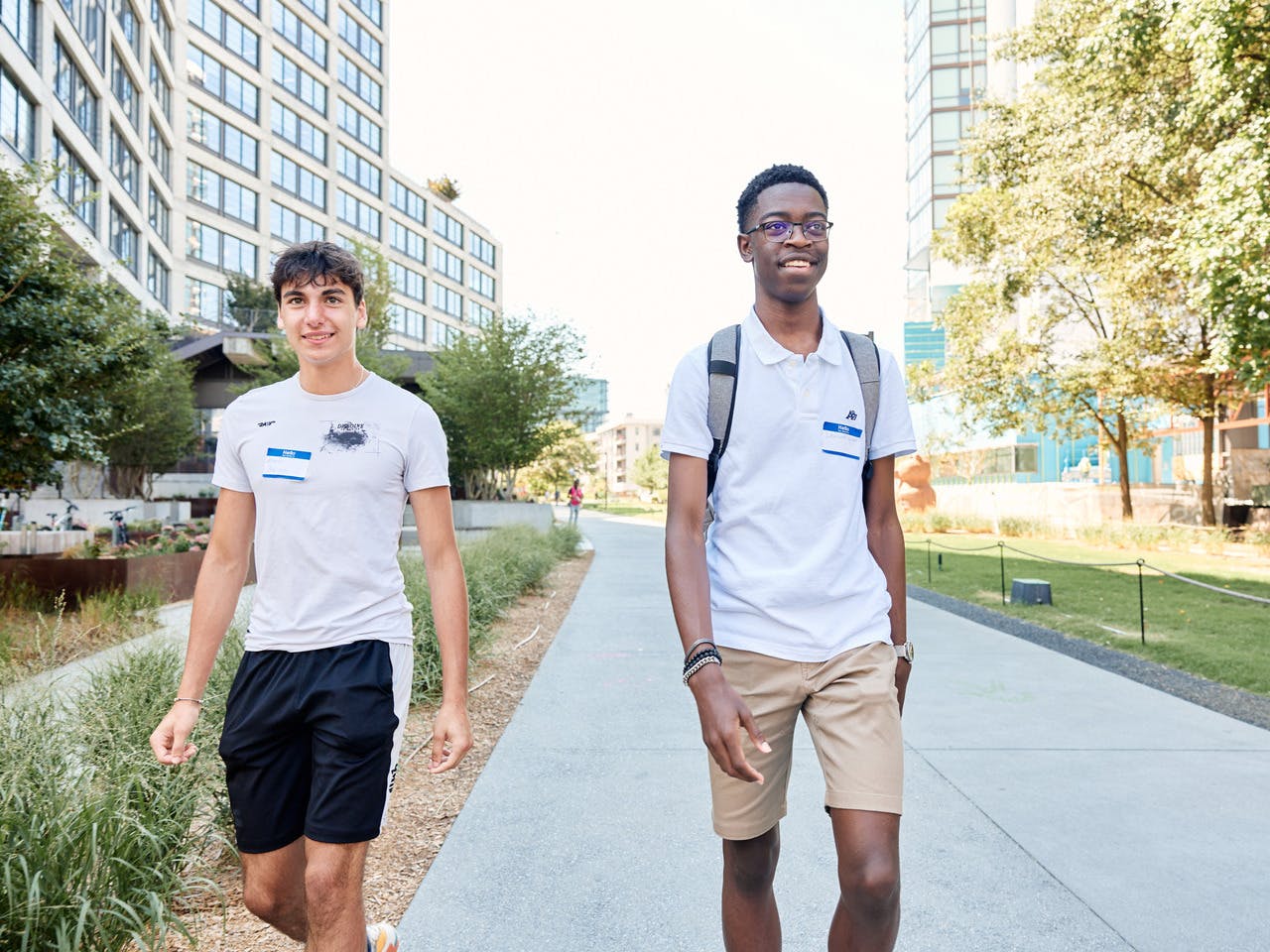 Two high school students walk together, smiling, along the Atlanta BeltLine Eastside Trail.