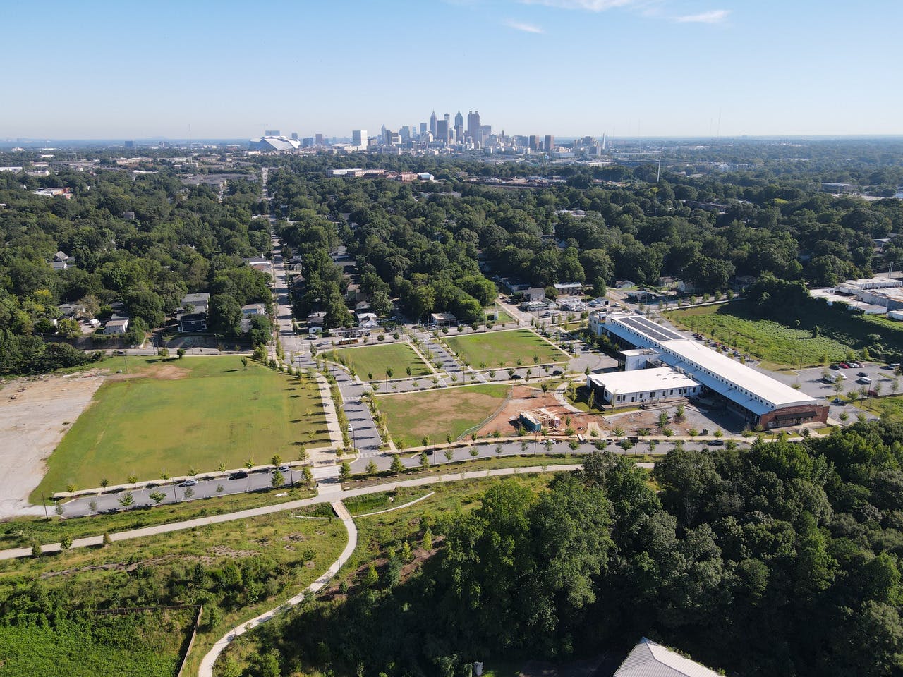 Bird's eye view of the Southside Trail, a large parcel of land, and several trees with the skyline in the distance.