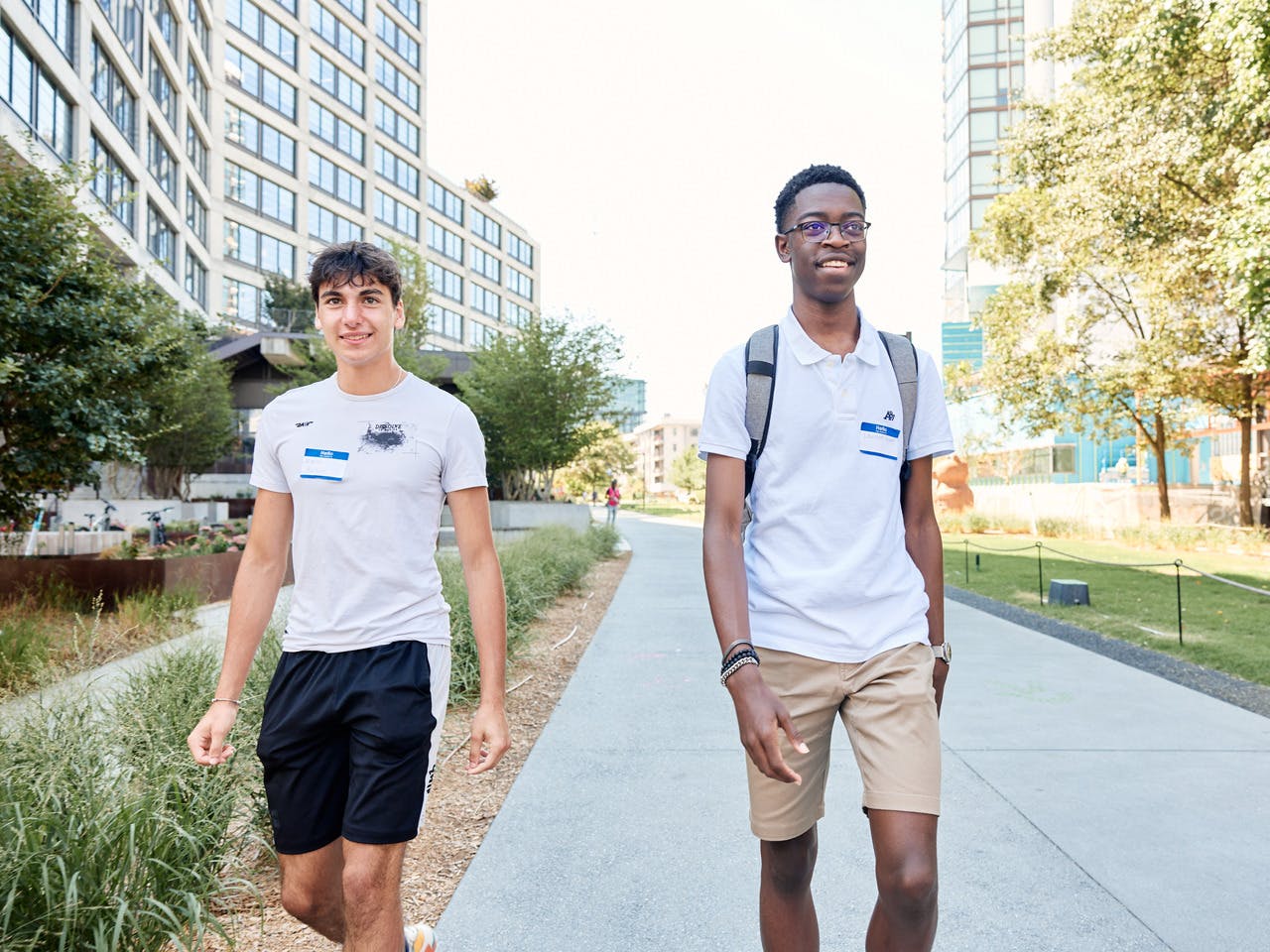 Two smiling students walk along the Atlanta Beltline trail.