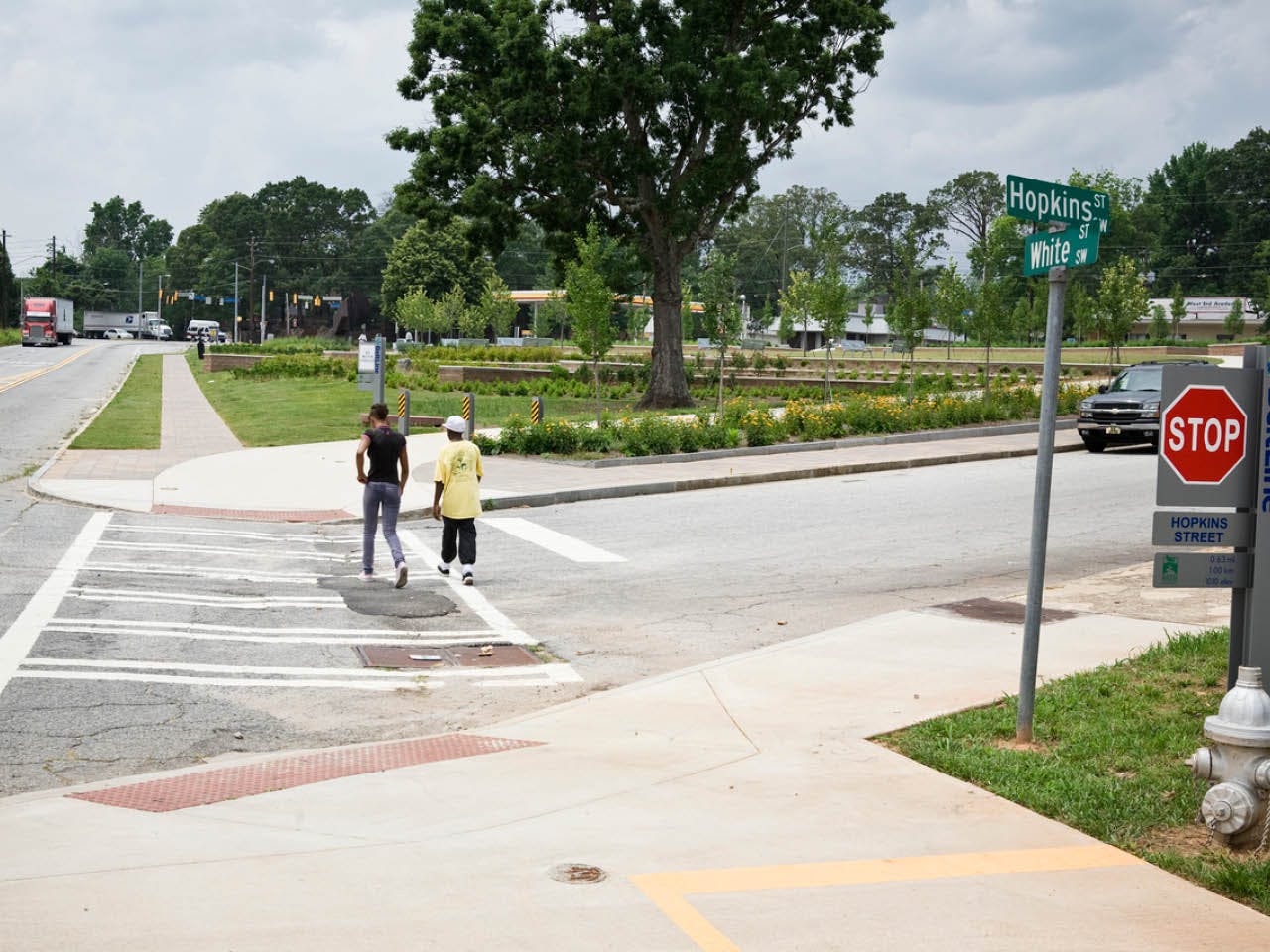 Two people cross Hopkins Street into Gordon White Park on the West End Trail. (Photo Credit: Christopher T. Martin)