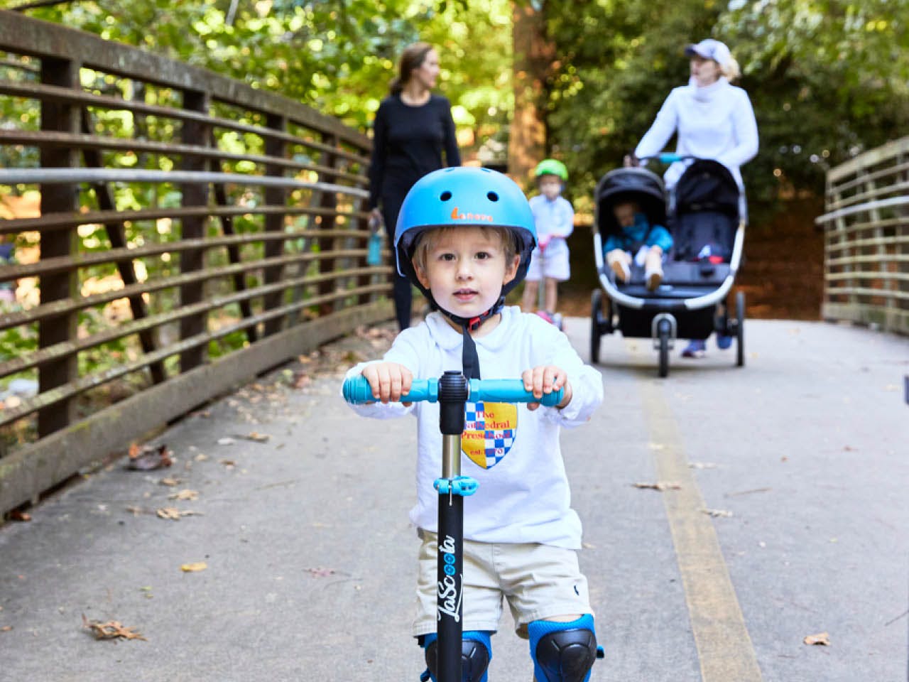 A boy rides his scooter with his family on the Northside Trail. Photo by Erin Sintos.