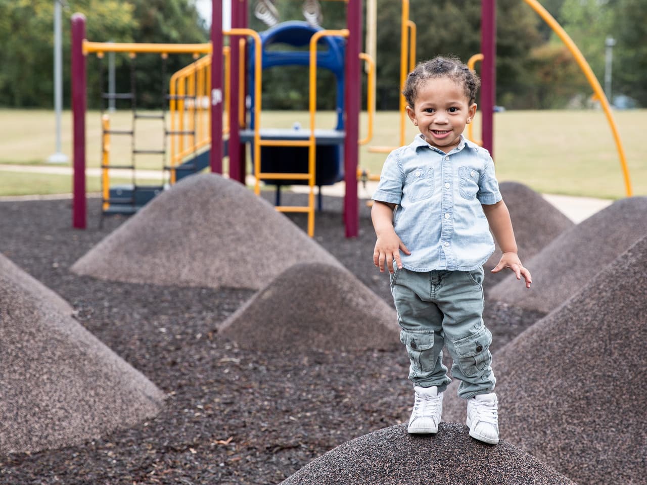 A happy child plays on a playground.