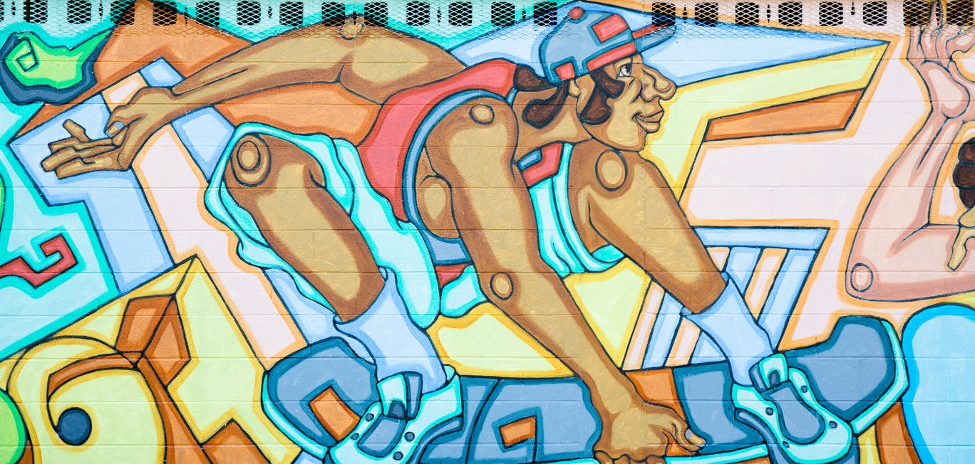 A colorful mural shows a man on a skateboard.