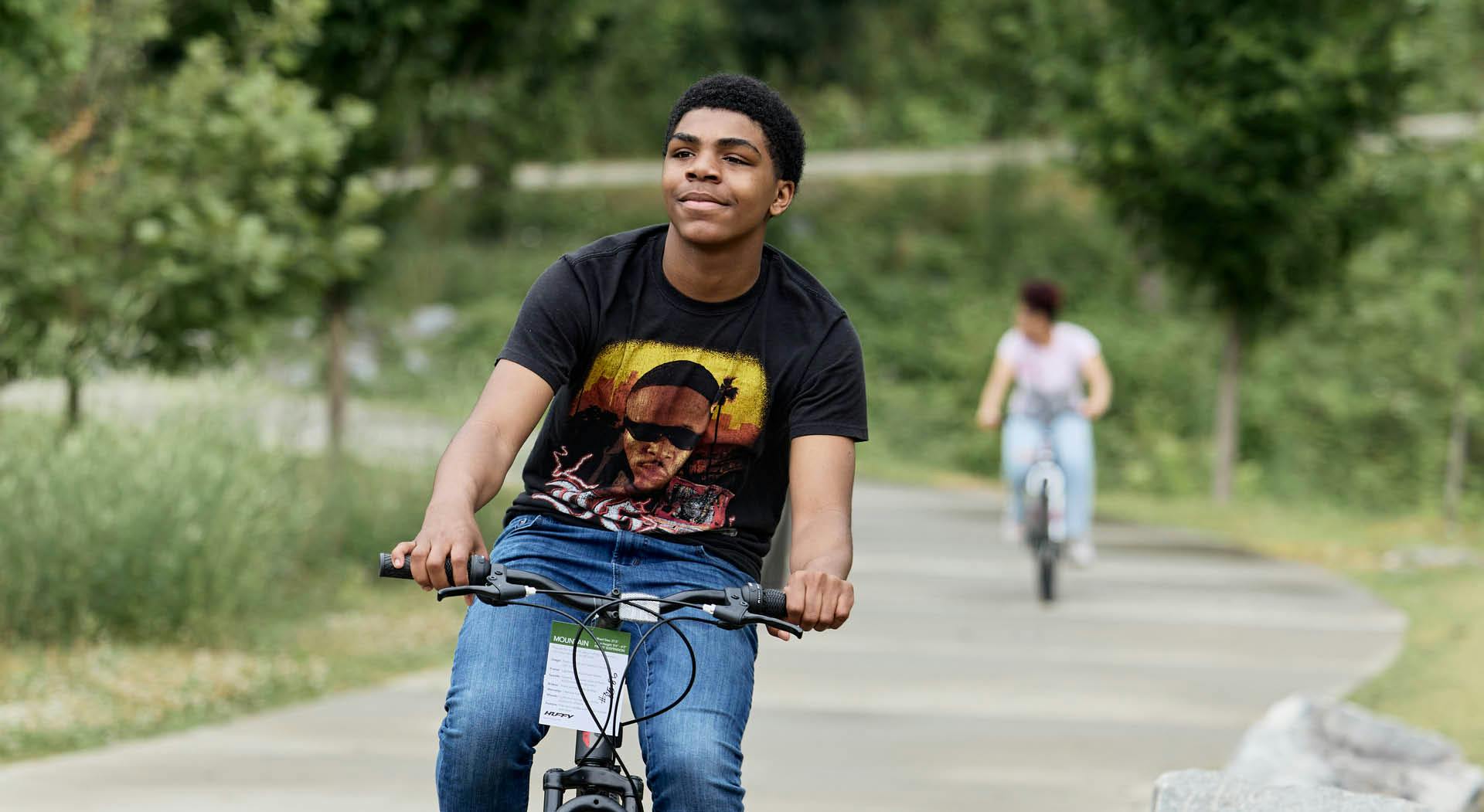 Young man rides a bike on the trails of Westside Park. (Photo Credit: Erin Sintos)