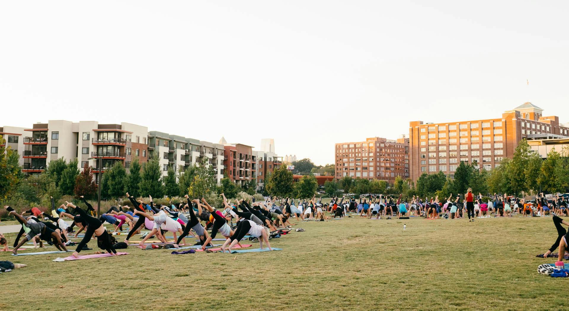 Hundreds of people participate in yoga on the great lawn at Historic Fourth Ward Park. (Photo Credit: Erin Sintos)