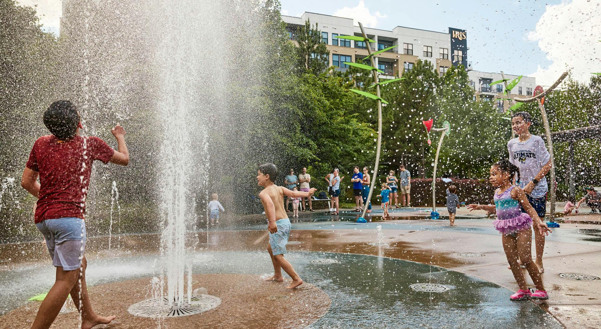 Water rains down on kids playing in the Historic Fourth Ward splash pad. (Photo Credit: Erin Sintos)
