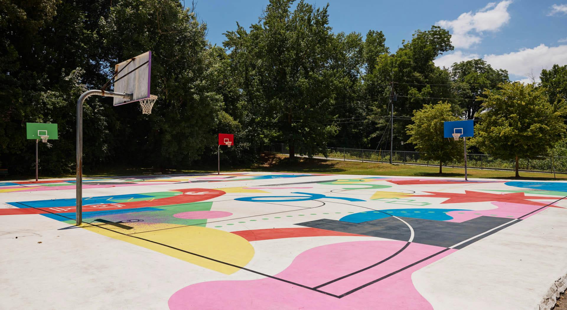 Overlapping basketball courts are painted with a colorful mural from the SCAD SERVE initiative. (Photo Credit: Erin Sintos)