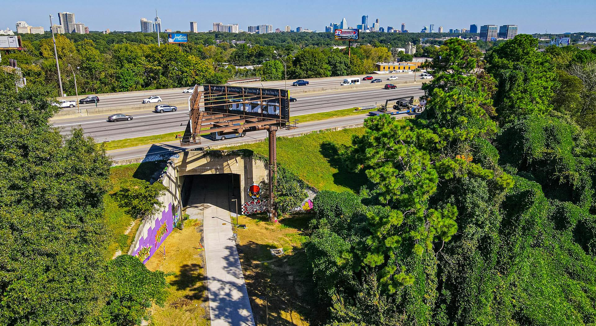 A bird's eye view of the Northeast Trail as it passes under I-85 with the Atlanta skyline in the distance. (Photo Credit: Erin Sintos)