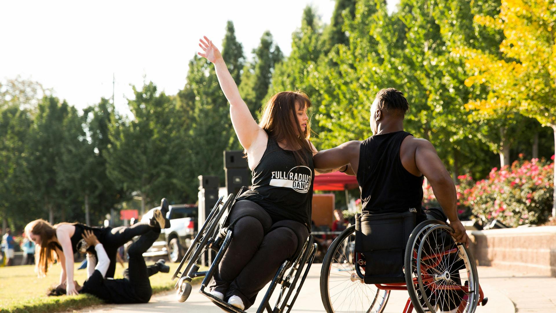 People perform a dance routine in wheelchairs.