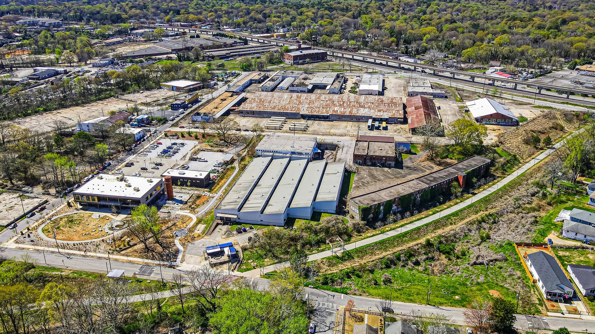 Bird's eye view of warehouse and industrial park showing buildings and parking areas adjacent to the Westside Trail.