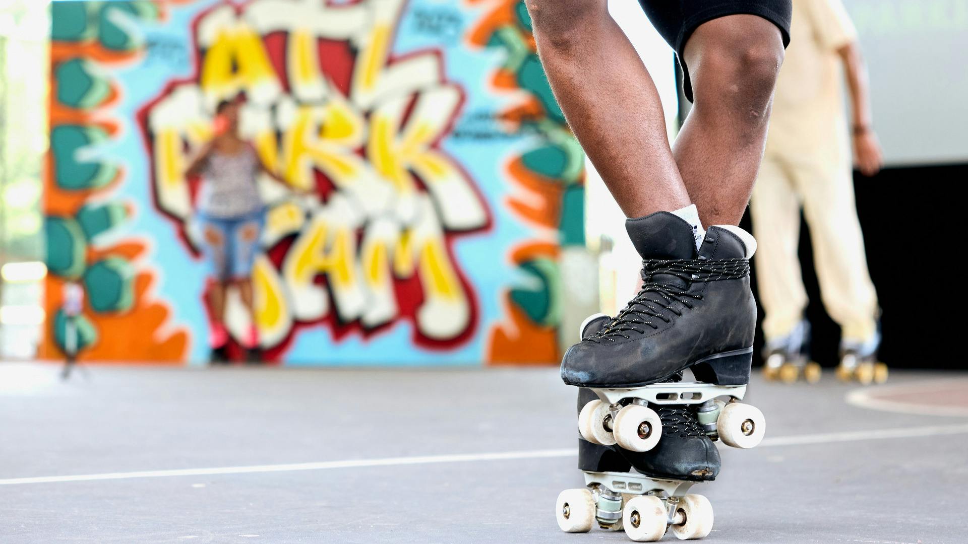 Roller skate feet with ATL Park Jam sign seen behind