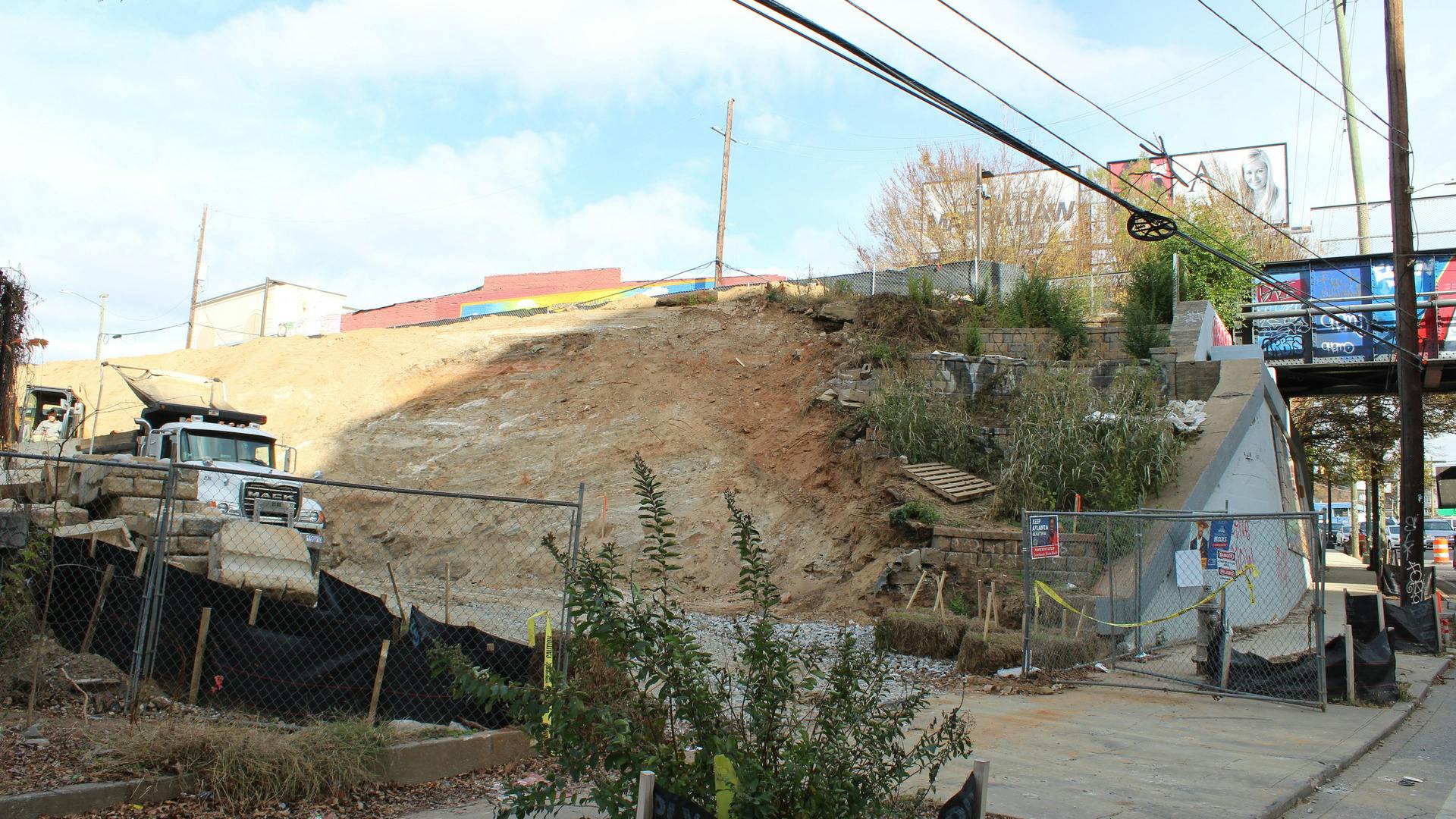 Construction equipment sits next to the future spot of a ramp.