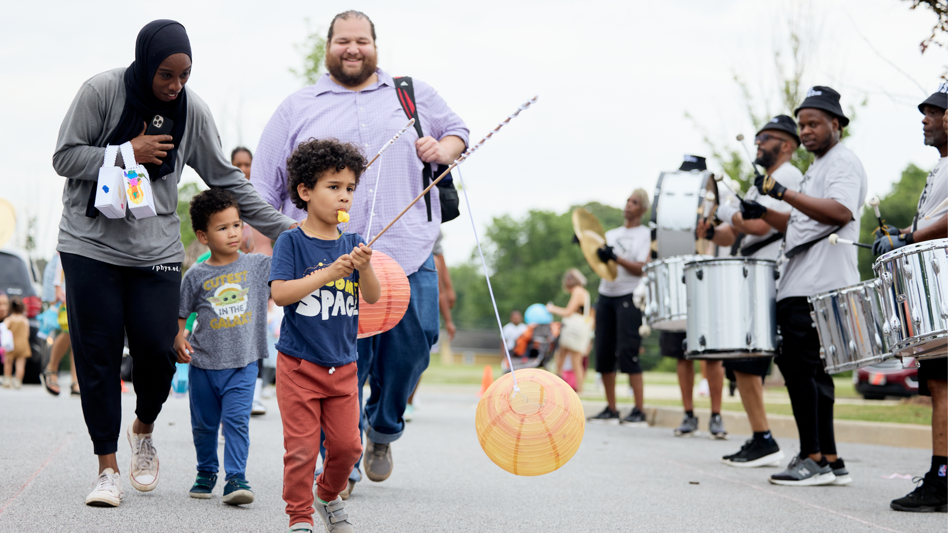 Children and their parents march with lanterns in the children's Lantern Parade at Pittsburgh Yards. (Photo Credit: Erin Sintos)