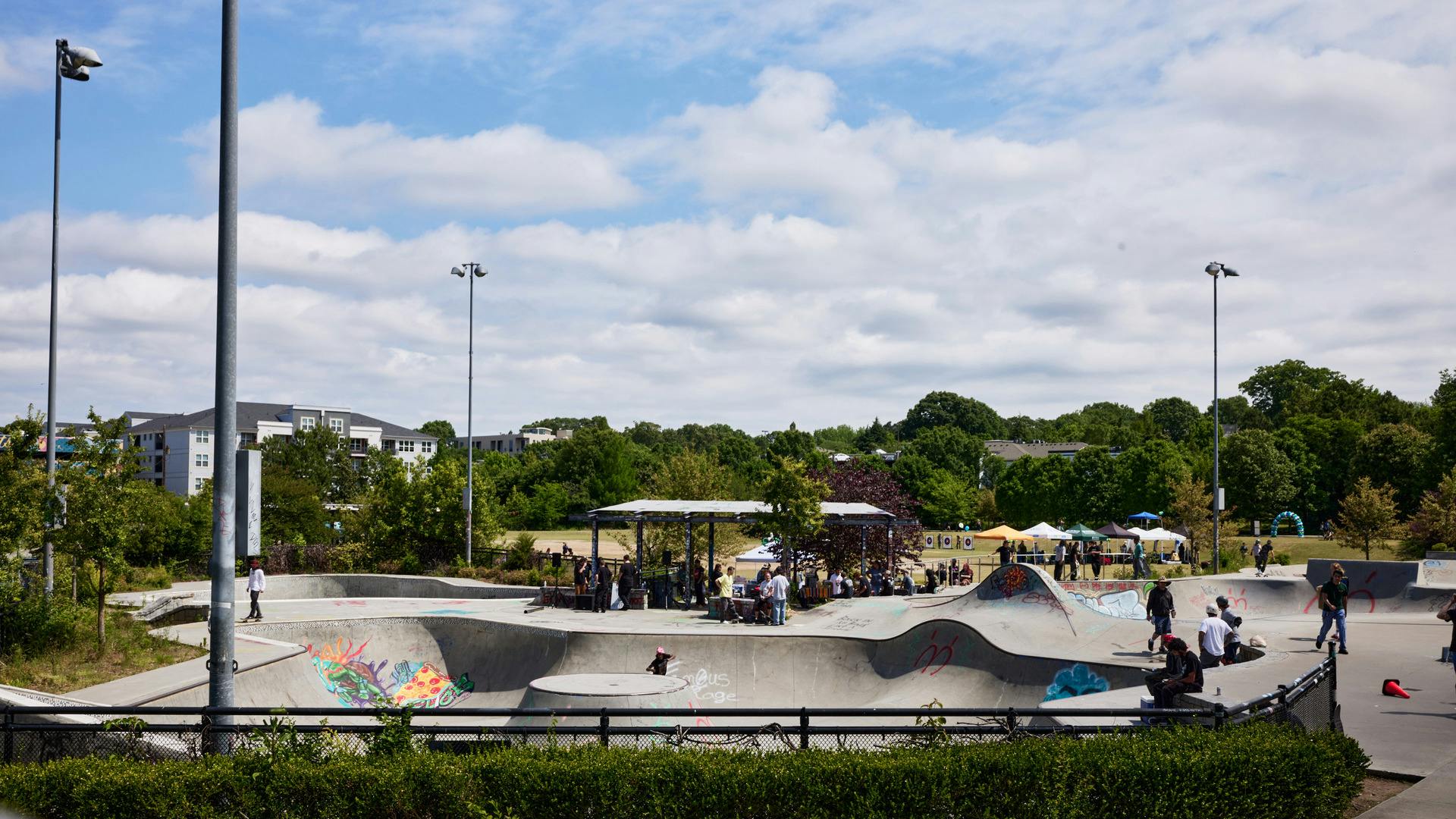 A skate park with people performing tricks on skateboards.