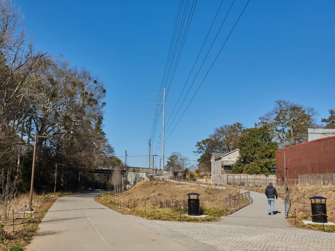 A man walk up the ADA-accessible ramp from the Northeast Trail to Montgomery Ferry Drive. (Photo Credit: Erin Sintos)