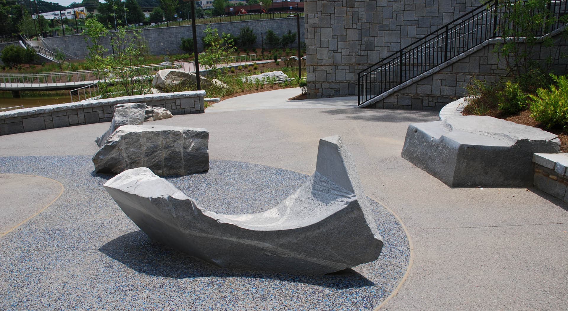 Curving granite sculptures made for seating by Maria Artemis.
