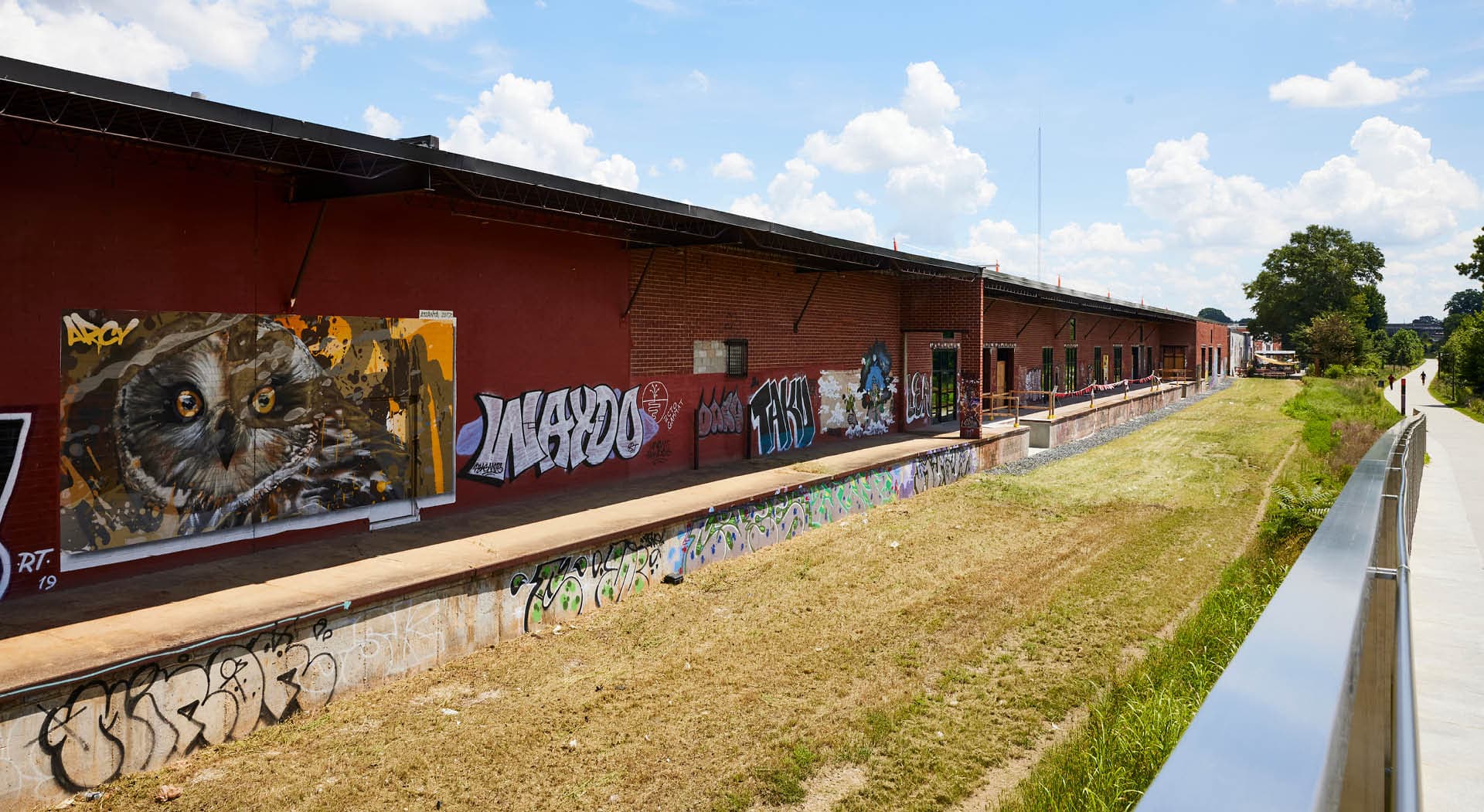 A mural of an owl by artist ARCY is painted on the back of a warehouse. (Photo Credit: Erin Sintos)