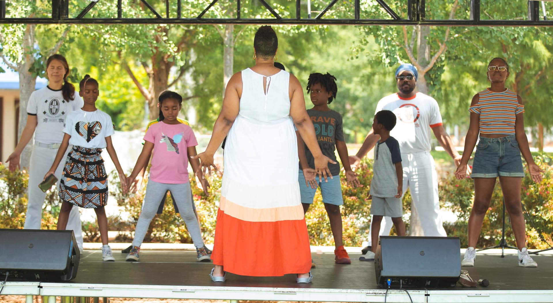 A woman leads a class on stage at the Juneteenth Festival in 2022 hosted by MuseSalon Collaborative. (Photo Credit: Timberhouse Films)