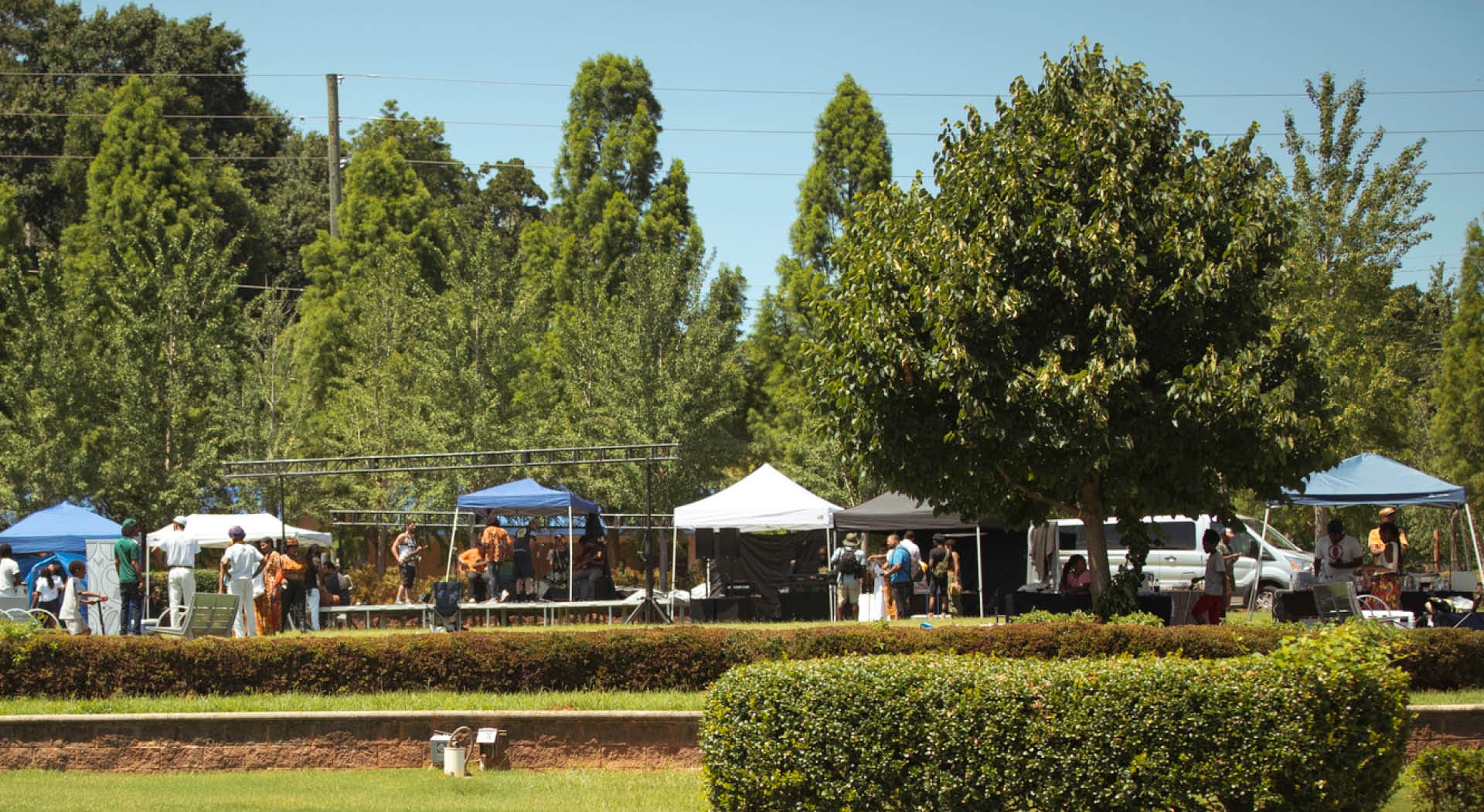 A row of tents line the paths at Gordon White Park at the Juneteenth Festival in 2022 hosted by MuseSalon Collaborative. (Photo Credit: Timberhouse Films)