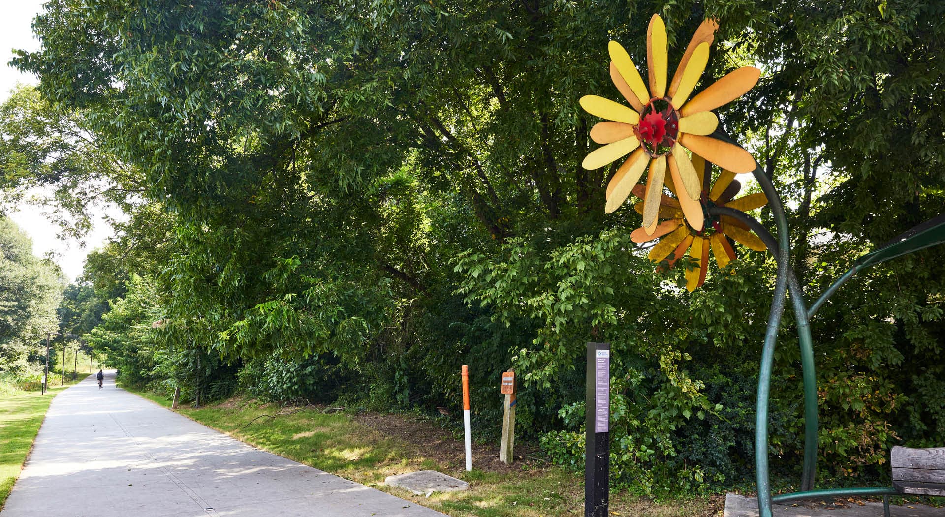 A large orange, yellow, and red metal flower sculpture titled "Blossom" by Richard Herzog. (Photo Credit: Erin Sintos)