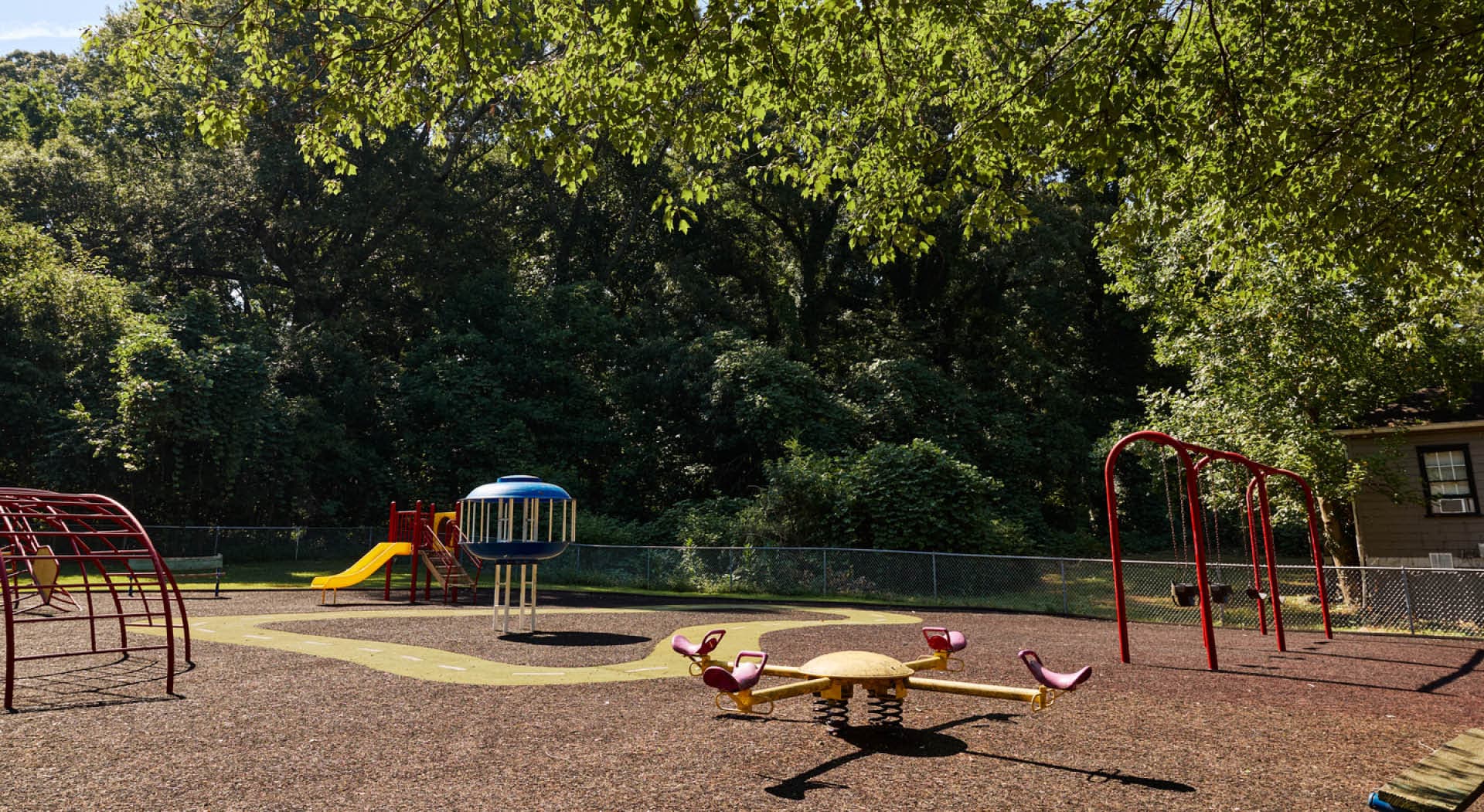 The playground with seesaws, swings, and climbing equipment at Enota Place Playlot. (Photo Credit: Erin Sintos)