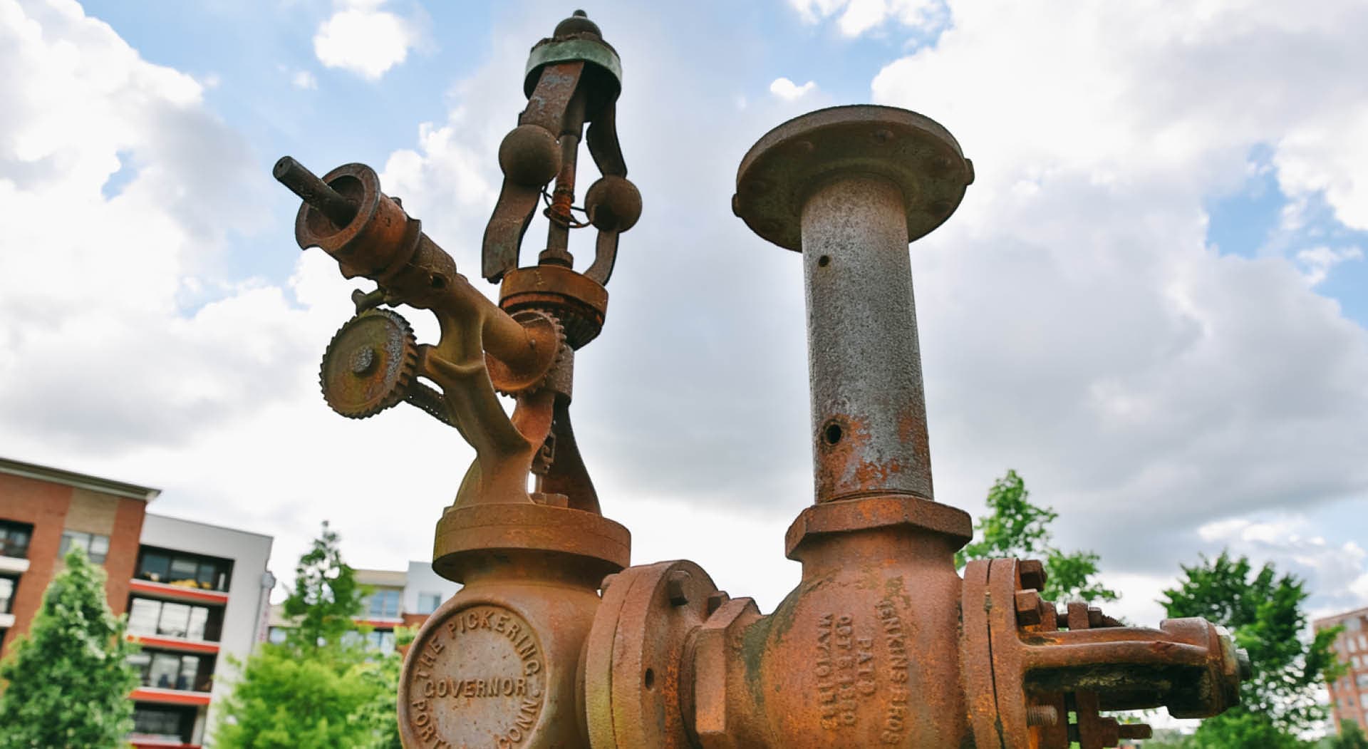 Detail of an historic steam engine from a mill that stands as a sculpture in the park. (Photo Credit: Erin Sintos)