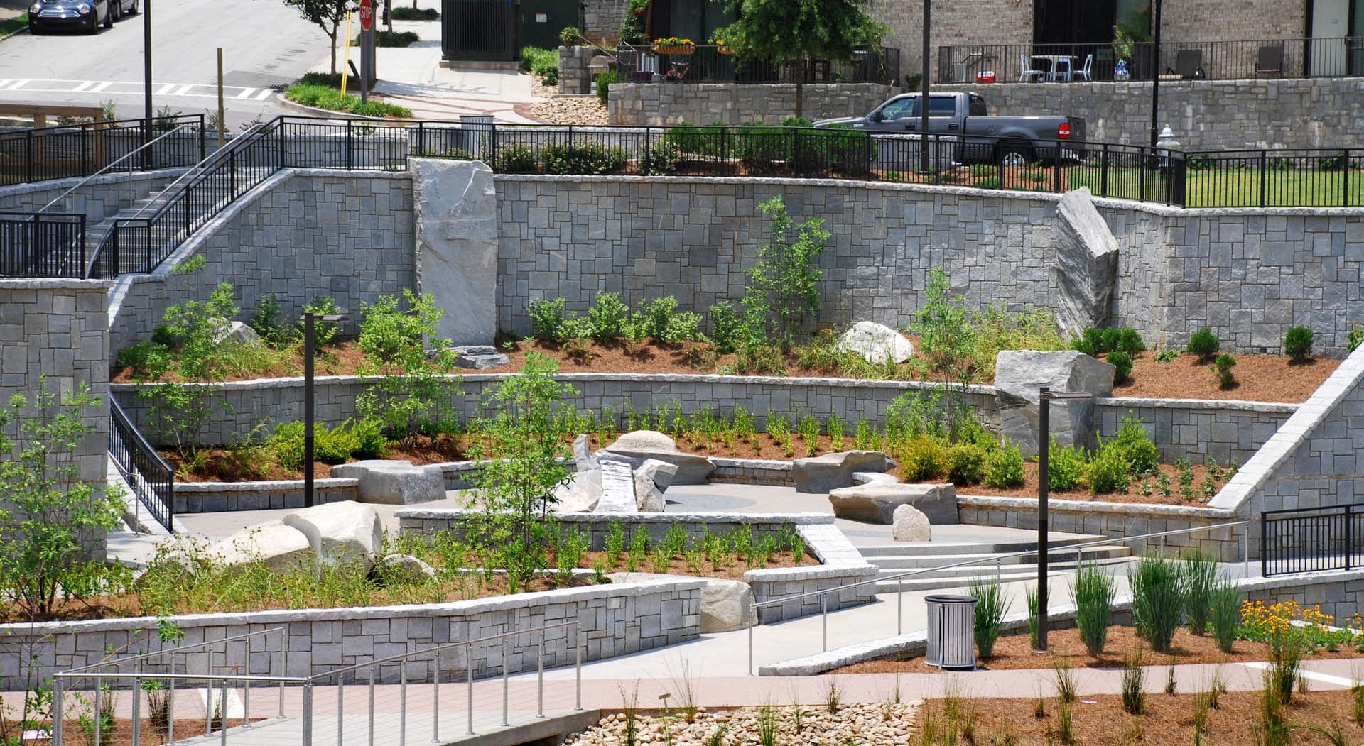 A plaza with granite sculptures made for seating by Maria Artemis.