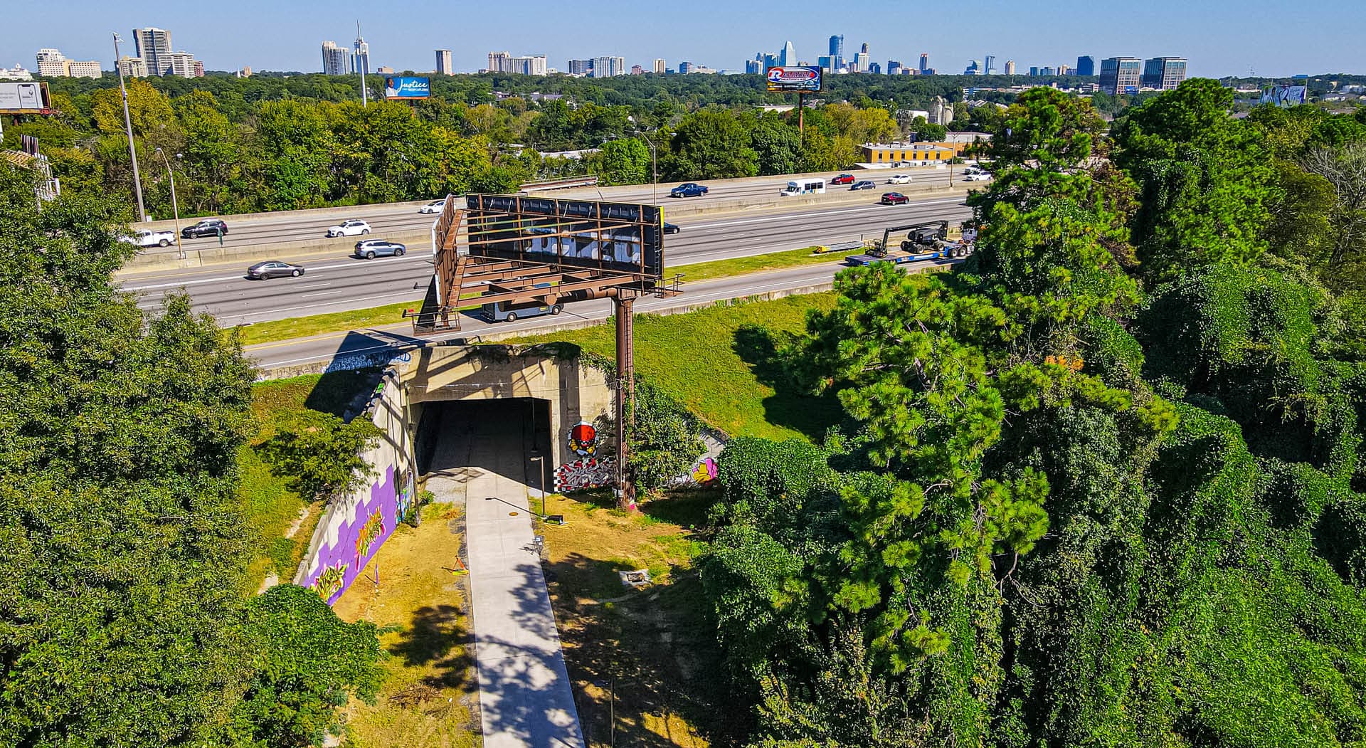 A bird's eye view of the Northeast Trail as it passes under I-85 with the Atlanta skyline in the distance. (Photo Credit: Erin Sintos)