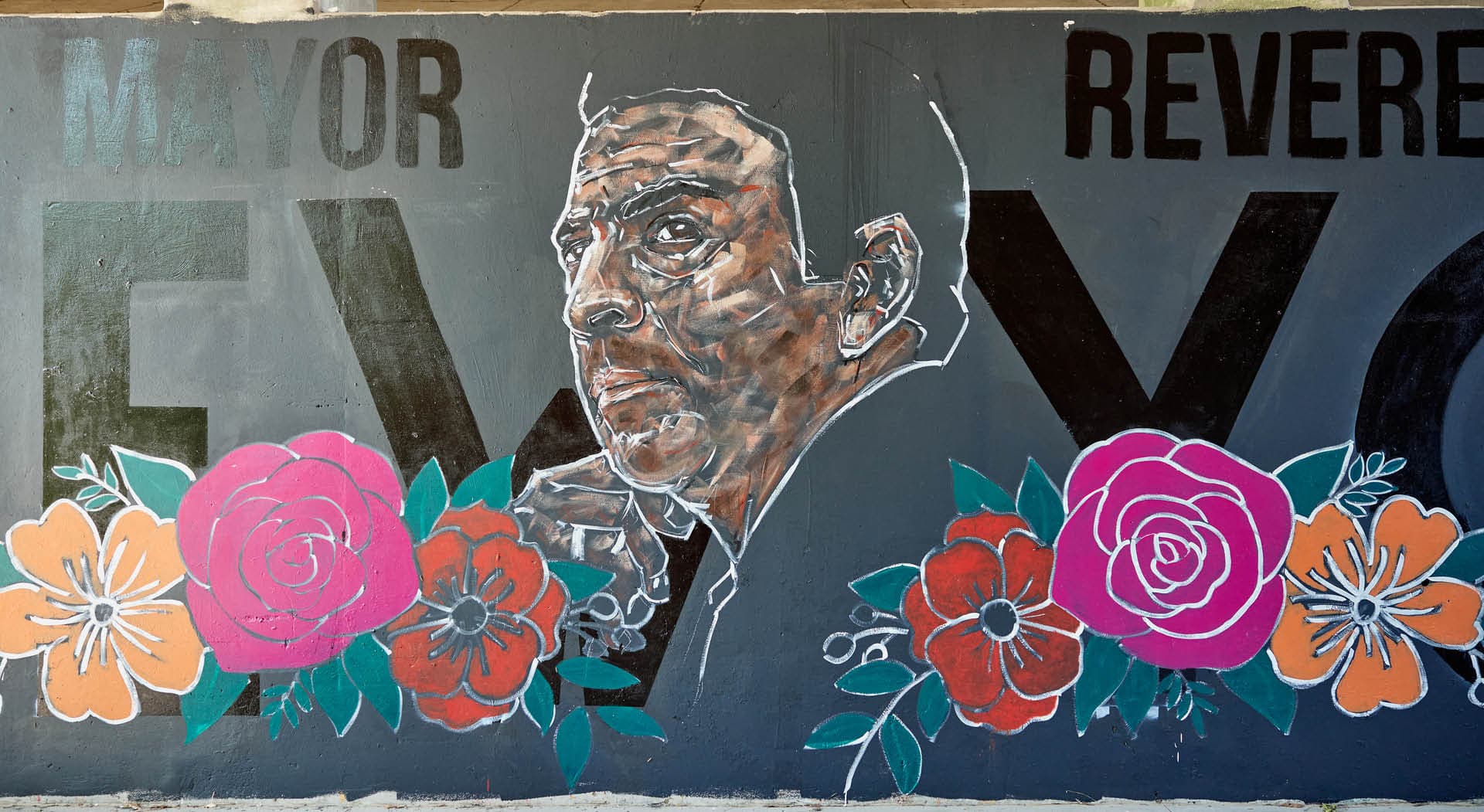 A mural depicting Ambassador Andrew Young with large flowers. (Photo Credit: Erin Sintos)