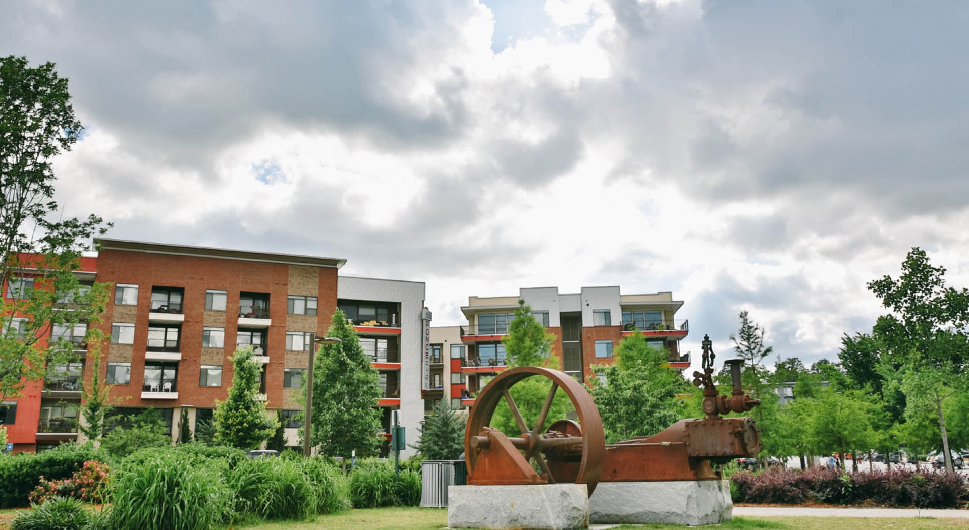 The historic steam engine from a mill stands on a stone pedestal in the park. (Photo Credit: Erin Sintos)