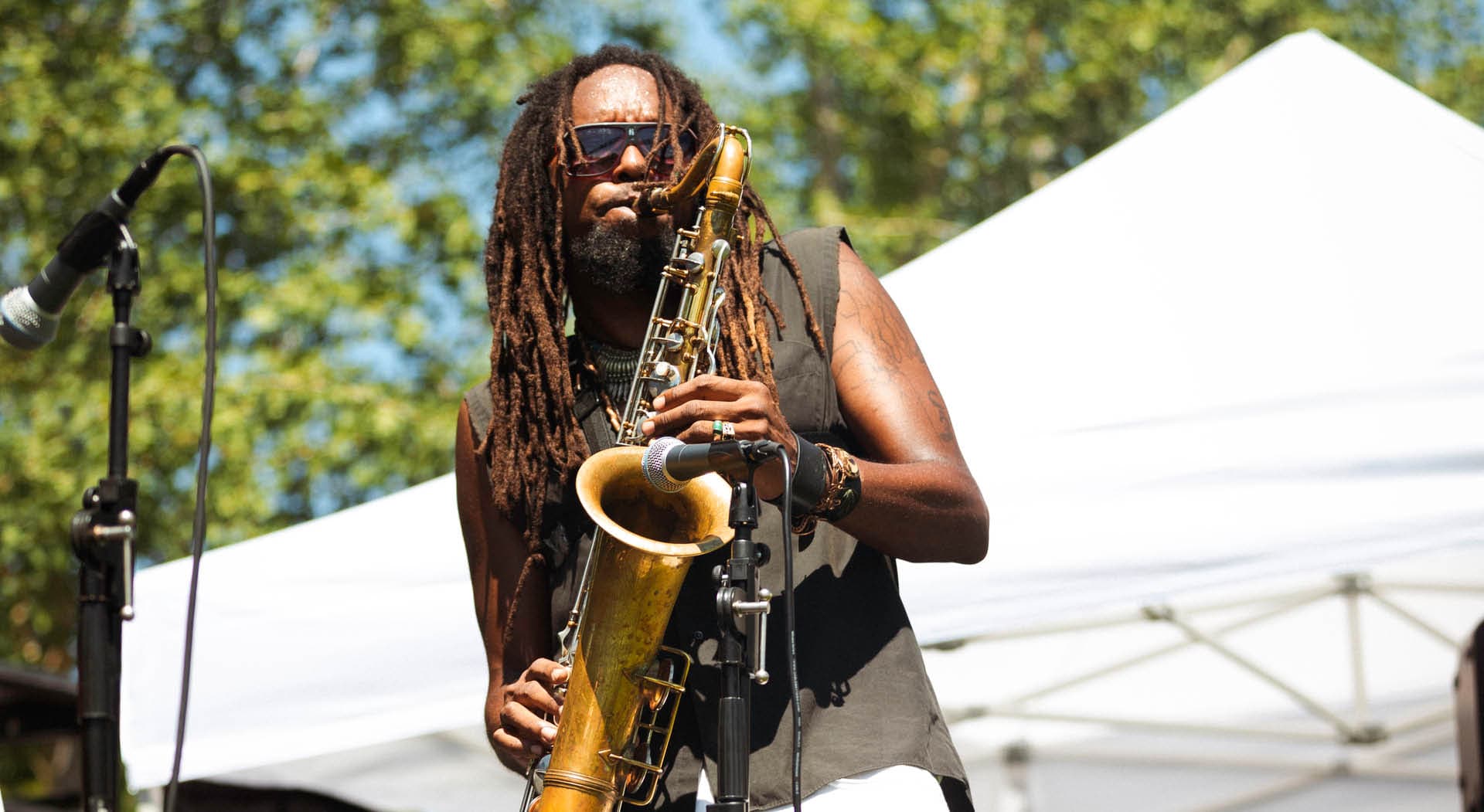 A man plays saxophone on stage at the Juneteenth Festival in 2022 hosted by MuseSalon Collaborative. (Photo Credit: Timberhouse Films)