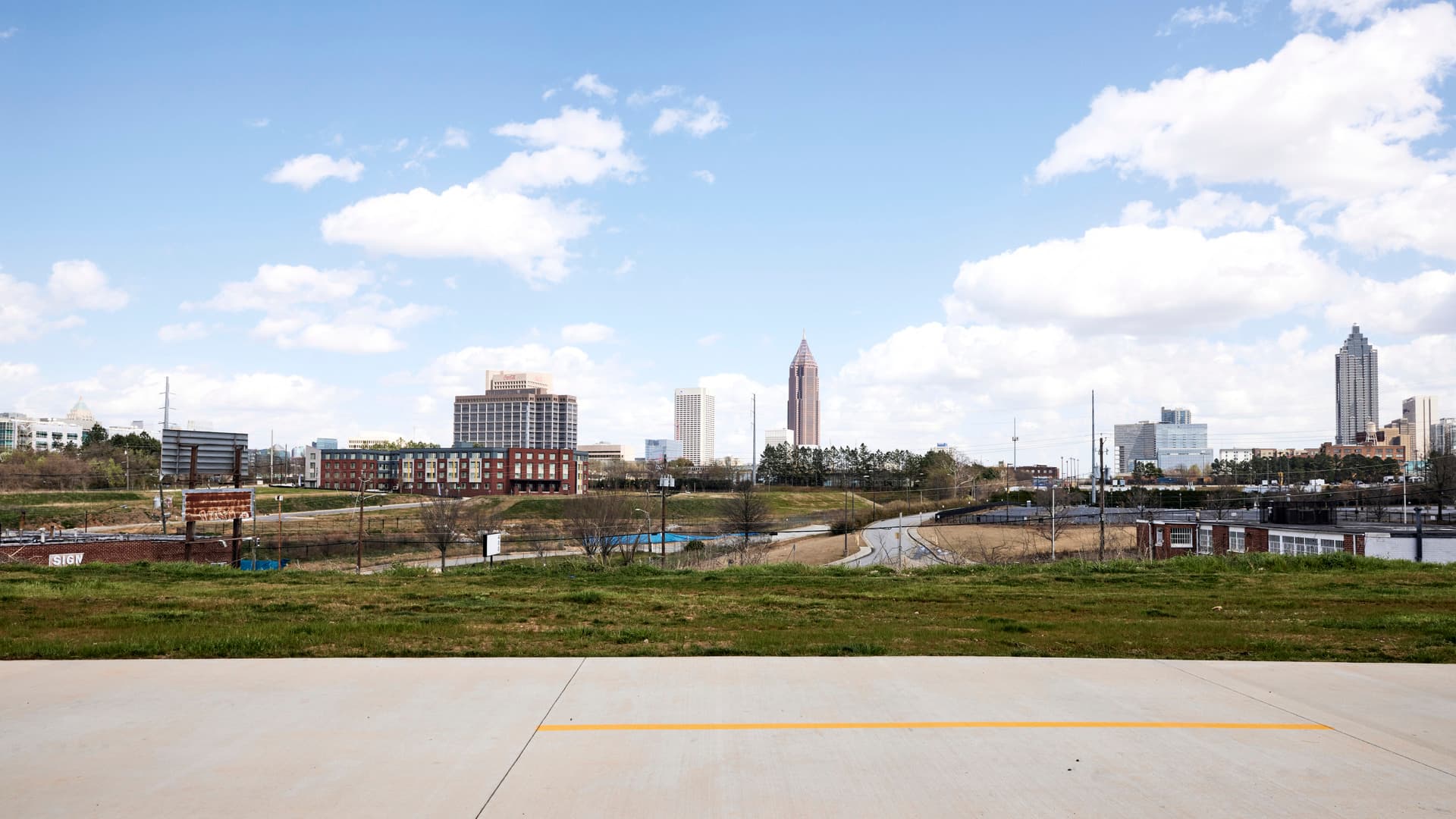 A pathway runs alongside a scenic view of downtown's skyscrapers.