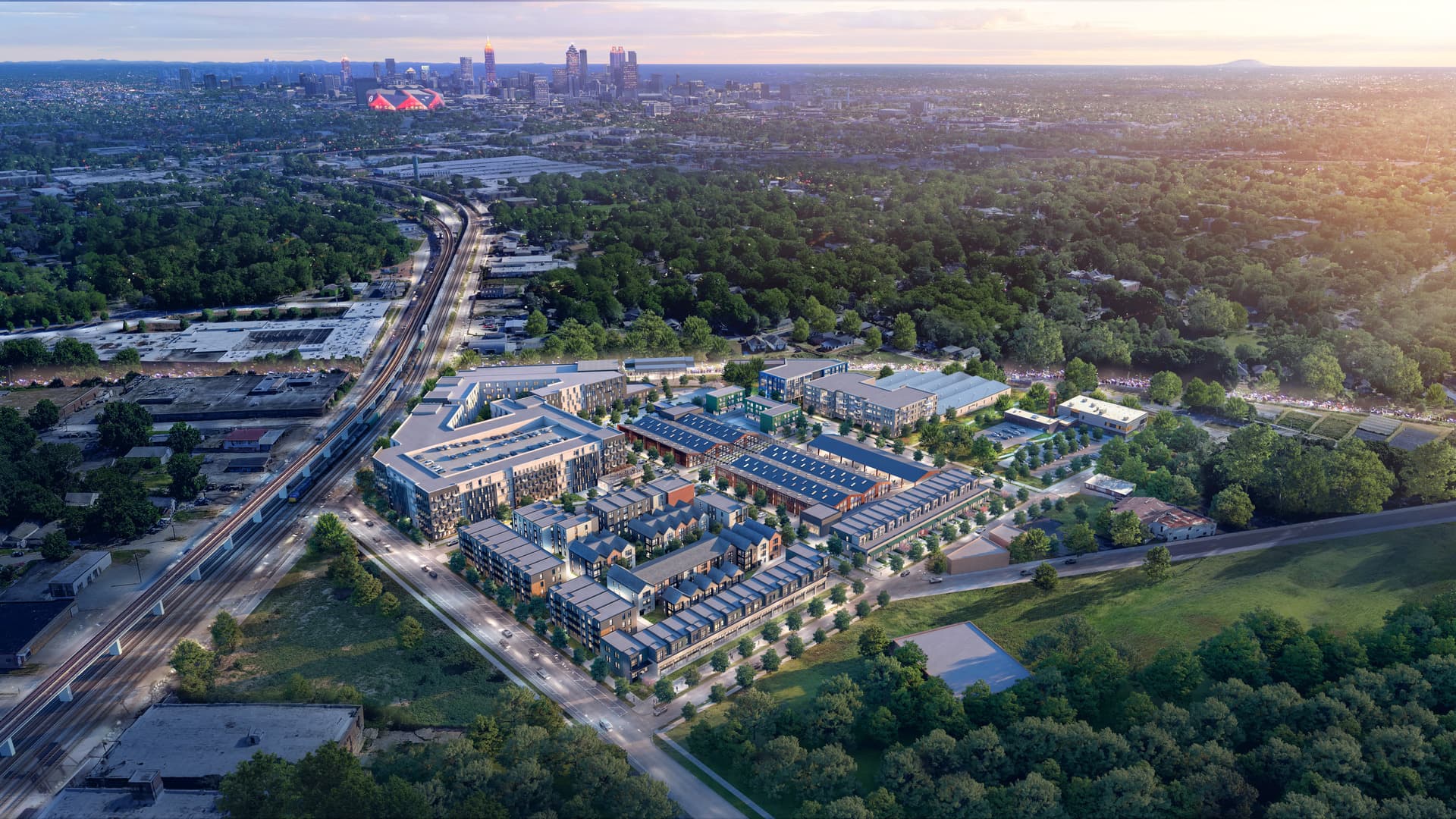 Aerial view of a modern residential complex surrounded by trees, with a city skyline visible on the horizon under a sunset sky.