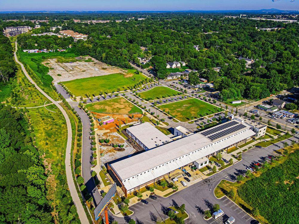 Atlanta BeltLine, Inc. purchased 13.7 acres at 356 University Avenue. The purchased property is pictured at the top of this image and adjacent to the Atlanta BeltLine Southside Trail, pictured to the left, and the grassy James Bridges Field and Pittsburgh Yards® in the foreground. Photo by LoKnows Drones. 