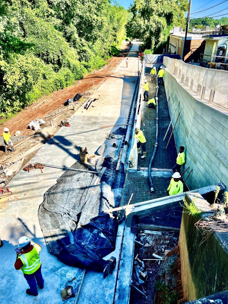 Concrete pouring underway on the ramp between the Northeast Trail and Piedmont Avenue. August 17, 2023. Photo by John Becker.