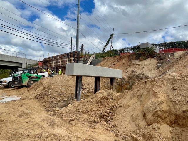 Looking north with Hollowell Parkway in the background, construction is underway on the retaining wall and ramp substructure for this access point and ramp on Westside Trail - Segment 4. October 26, 2023. Photo by Kerri Parker.