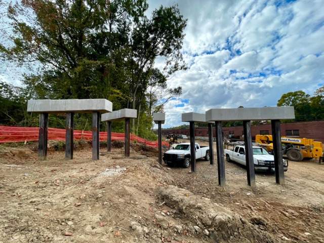 Driven steel piles with cast in place concrete caps which will support the next phase of work - installation of steel beams or girders to support a new curved access ramp up to Hollowell Parkway from Westside Trail - Segment 4. October 26, 2023. Photo by Kerri Parker.