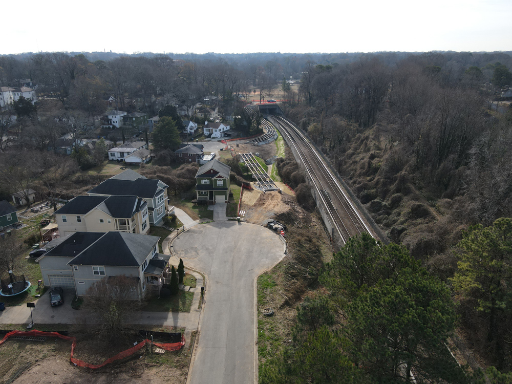 Westside Trail - Segment 4: looking south along Washington Manor Drive at trail construction with MARTA's green line to the right (west). December 21, 2023. Photo by LoKnows Drones.
